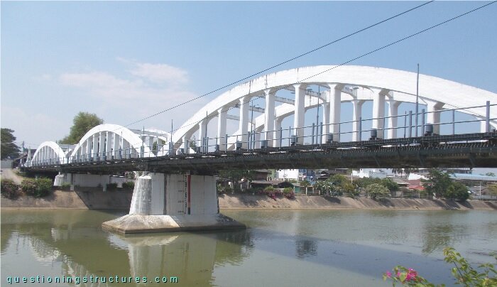 Reinforced concrete  ted-arch bridge over a river.