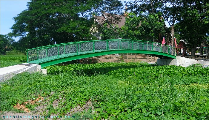 Steel arch bridge over a river.