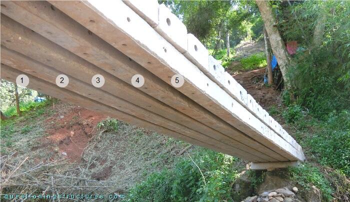 Prestressed concrete utility pole bridge viewed from the bottom