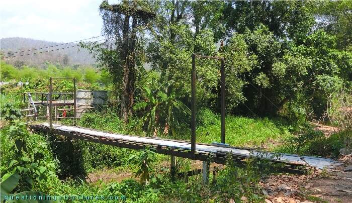 Self-anchored suspension bridge over a river