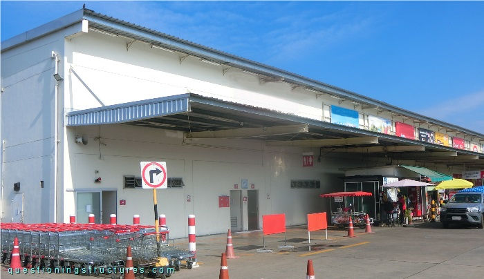 Steel canopy roof with double-tapered I-beams, suspension rods, fly braces, sag rods , and roof cross braces.