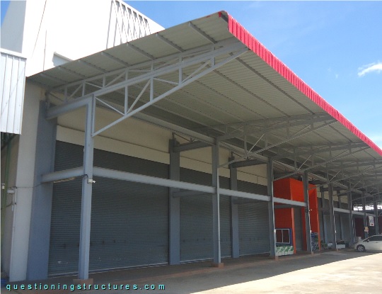 Industrial steel canopy roof with stacked trusses (link-image to canopy roof 16).