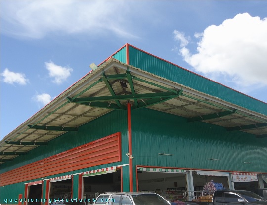 Industrial steel canopy roof with cross bracing, front ties, and fly bracing (link-image to canopy roof 17).