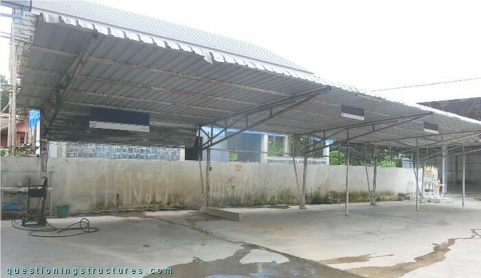 Freestanding steel carport with back braced tapered steel trusses