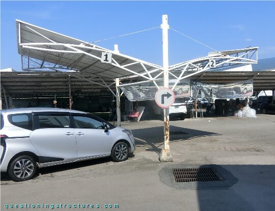 Freestanding steel carport with trusses and stay cables (link-image to parking lot structure 9)
