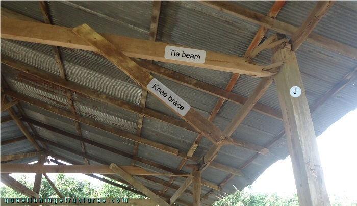 Damaged knee brace and tie beam of a timber farm hut